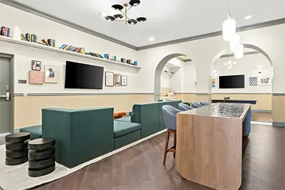 Club room at Identity Dinkytown with large TVs and gaming tables for student residents to socialize